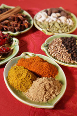 three piles of indian powder spice on plate