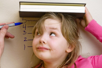 child watching herself get measured