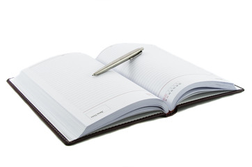 Fototapeta premium Close up noutbook and pen on it isolated over white