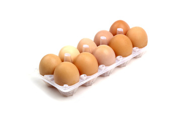 Dozen of brown eggs in plastic package isolated on white backgro