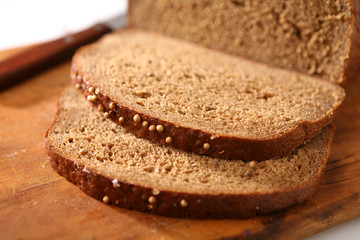 Slices of rye-bread on wood surface.