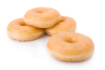 Four doughnuts or donuts piled isolated on white.
