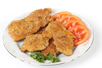 Tasty schnitzels on light background