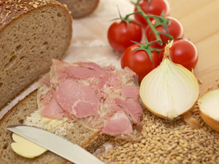 freshly  baked bread, ham in aspic jelly, vegetables, grains