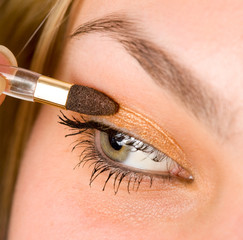 Woman applying makeup