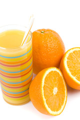 glass of juice and oranges