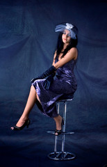 Series. Portrait of the beautiful brunette in a dark blue dress