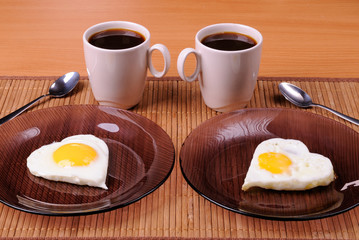 Fried eggs and two cups of black coffee