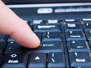 Fototapeta na wymiar human finger on the keyboard