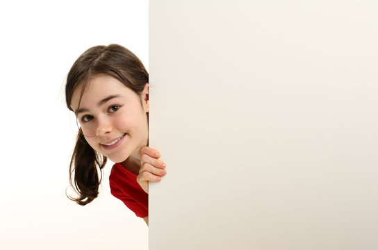 Girl peeking behind wall