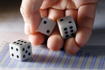 throwing dices onto financial graph