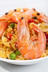 Spanish paella in a white bowl close-up
