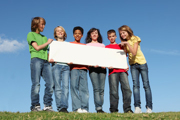 diverse group of kids at summer camp holding  banner - 12477846