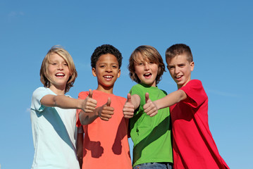 happy group of diverse children thumbs up