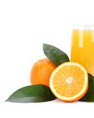 Fruits with green leaves and glass of juice