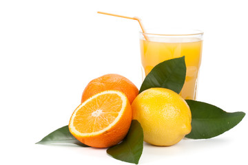 Fruits with green leaves and glass of juice