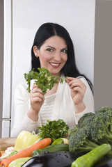 Happy woman with fresh parsley and vegetables © Gabriel Blaj