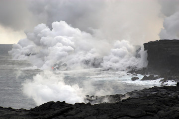 Fototapeta na wymiar Lava flowing into the ocean