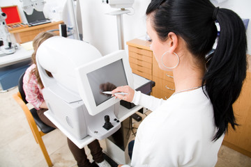 Young doctor exam a patient in ophthalmology laboratory