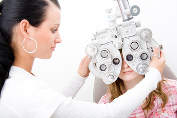Beautiful young doctor inspect a patient in ophthalmology labor