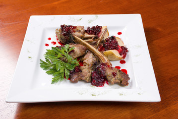 meat lamb on rib with cowberries by sauce