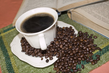 cup of coffee with loose coffee beans
