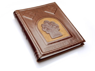 Closed leather Russian ancestry book over white background