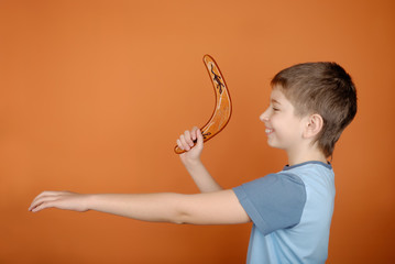 Boy with a boomerang - obrazy, fototapety, plakaty