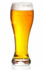 Glass of beer close-up with froth over white background