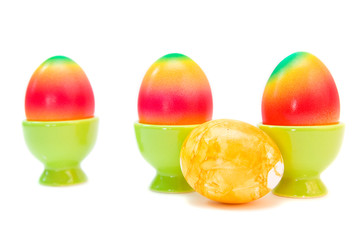 colorful eggs in eggcups isolated on white.