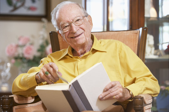 Senior man reading book - Powered by Adobe