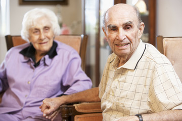 Senior couple relaxing in armchairs