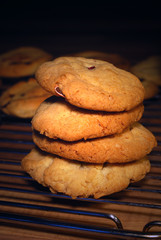 Four homade chocolate chip cookies on a rack
