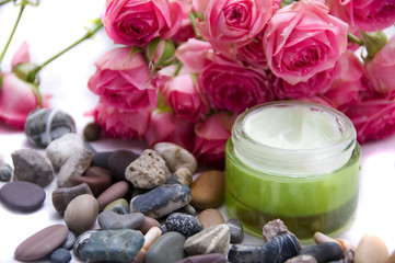 natural cosmetics - roses, pebbles, and cream
