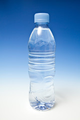 Bottled water on a graduated blue studio background.