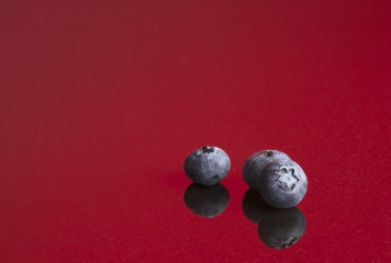 Blueberries on red background