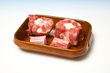 Roasting dish with ox tail meat isolated.