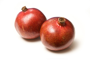 Pomegranetes isolated on a white studio background.