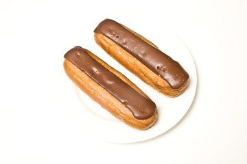 Cream eclairs isolated on a white studio background