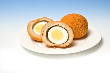Scotch eggs on a blue studio background