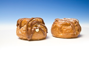 Cream buns on a blue studio background.