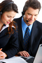 Smiling  business people  with headsets. Over white background .