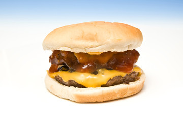 Cheeseburger on a graduated blue studio background.