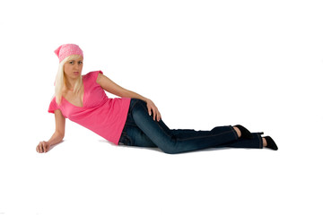 blonde in a pink blouse and blue jeans laying