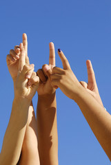 Many hands pointing to the sky