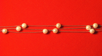 beads from paste pearl on a red background