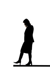 Silhouette of a woman walking on a board