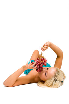 blonde girl in blue with grapes