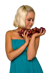 blonde girl in blue with grapes