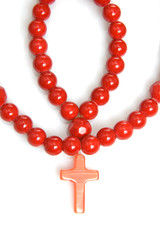 Red coral beads on a white background